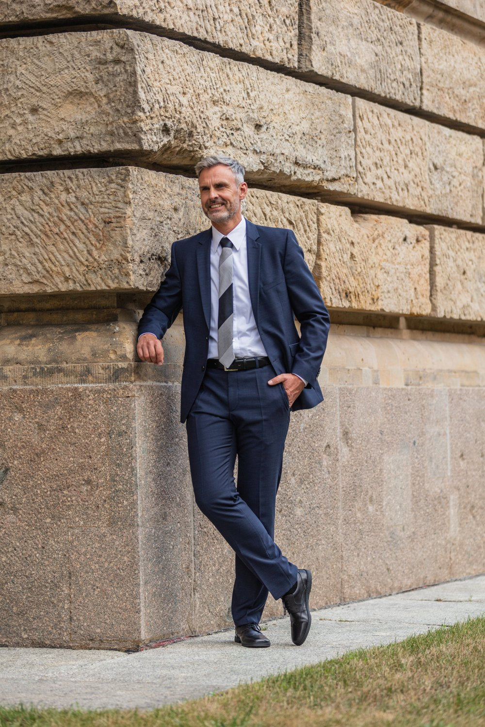 A pair of black leather BRIQ Prime oxford shoes from ZAQQ with lacing, where one shoe rests on top of the other against a white background. These elegant business shoes exude sophistication and are equipped with a comfortable barefoot sole for all-day wear.