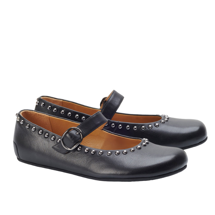 The ballerinas DIEQO Nappa Black from ZAQQ Made of black nappa leather, they have a strap with a buckle and are decorated with silver rivets on the edges. Photographed against a white background, these stylish shoes support natural foot movement for comfort and elegance.