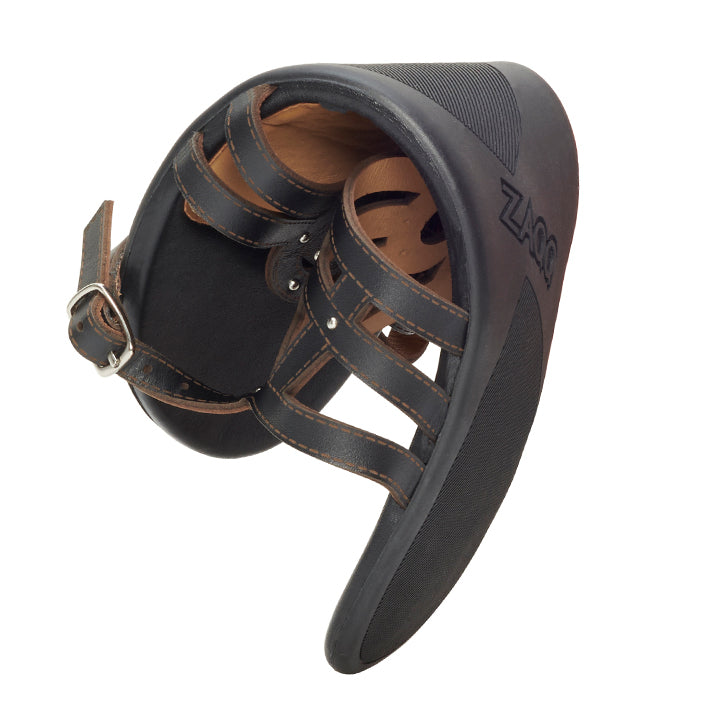 The QANQETA Black, a protective shoe for horses from ZAQQ, is designed in black and brown for exceptional comfort with multiple straps and a durable sole. It combines the durability and style reminiscent of fine nappa leather, the brand name ZAQQ is discreetly printed on the side.