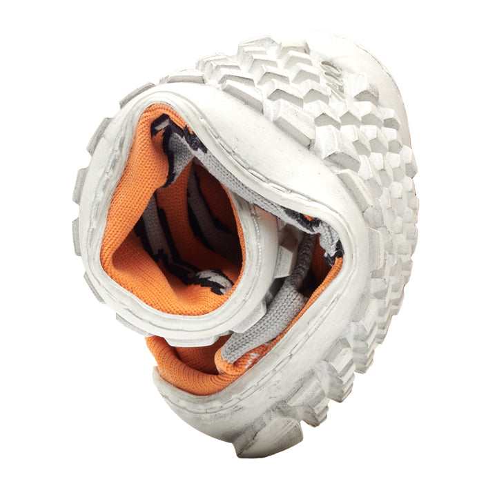 The SOQQ Eye Orange sneaker from ZAQQ with its flexible design reminiscent of a barefoot shoe, is curved in the middle to reveal its orange interior and textured sole. Its design elements focus on comfort, showing both comfort and versatility.