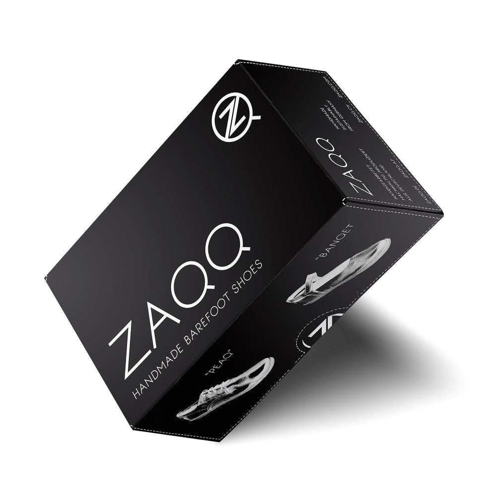 An elegant black shoe box with the ZAQQLogo features the phrase “Handmade Barefoot Shoes” and images of minimalist barefoot shoe designs that emphasize artisan craftsmanship. This packaging perfectly complements the QORE Low White range made from luxurious nappa leather.