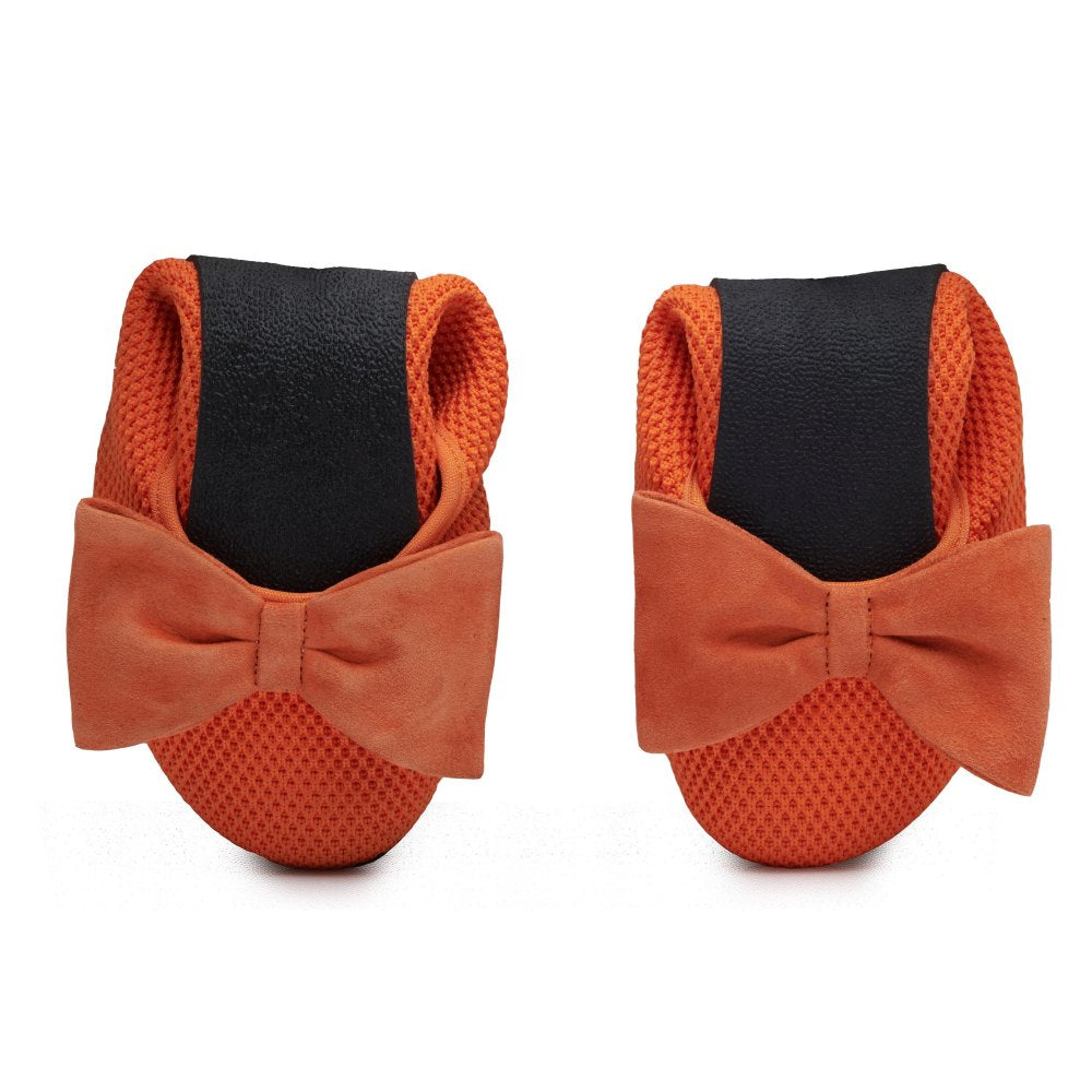 A pair of TWIST Orange Dog Boots from ZAQQ with black elastic cuffs and pretty orange bows at the top. Crafted from a textured, breathable fabric for optimal comfort and style, these boots offer your pet the same elegance that a comfortable ballet flat offers its wearer.